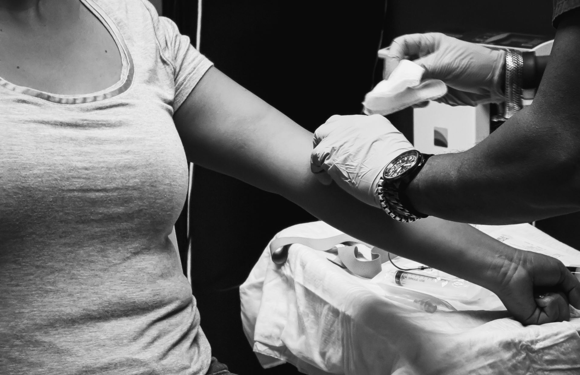 black and white image of someone having a blood test